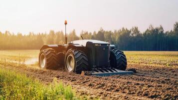 Tractor plowing a field during golden hour with lush trees in background photo
