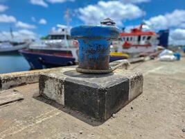 Mooring bollard with rope to tie the ship when docked photo