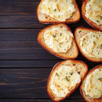 Sliced bread with herb spread on a rustic wooden table. photo