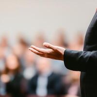 Hand gesturing during a presentation in front of an audience. photo