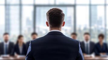 Businessman presenting in front of an audience in a modern conference room. photo