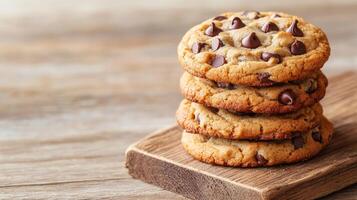 Stack of chocolate chip cookies on a wooden plate. photo