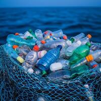 Plastic bottles collected in a net, floating on water. photo