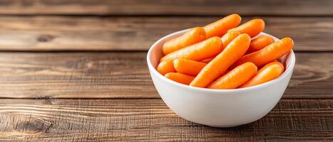 Bowl of fresh carrots on a rustic wooden table. photo