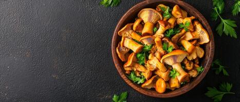 Delicious chanterelle mushrooms in a rustic bowl on a dark surface. photo