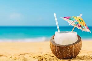 Coconut drink with an umbrella on a sandy beach. photo
