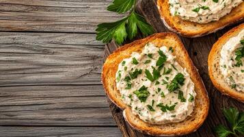 Creamy spread on toasted bread garnished with herbs. photo