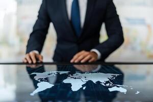 Business professional interacting with a digital world map interface. photo
