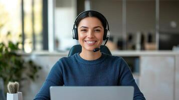 Smiling woman in headset working on a laptop at a modern office. photo