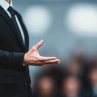 Professional hand gesture in business attire during a presentation. photo