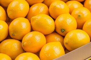 Bright, fresh oranges stacked together in a display. photo