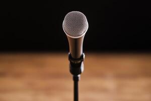 Microphone on a stand in a dimly lit environment. photo