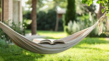 Cozy hammock with an open book in a serene garden setting. photo
