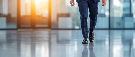 Businessman walking in a modern, reflective office space. photo