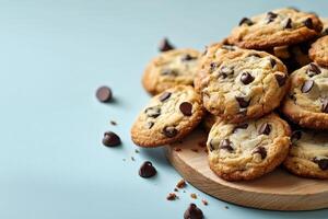 Freshly baked chocolate chip cookies on a wooden platter. photo