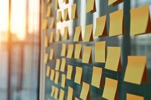 Sticky notes on a glass wall in a modern office setting. photo