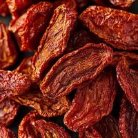 Dried red chilies stacked closely together, showcasing rich textures. photo