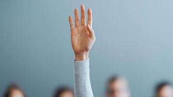 Raised hand in a classroom or meeting setting. photo