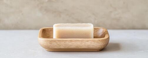 Soap bar on a decorative dish against a neutral background. photo