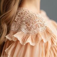 Elegant lace detail on soft fabric shoulder. photo