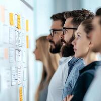 Team analyzing project notes on a wall in a modern office setting. photo