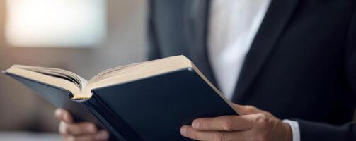 Elegant man holding a book in a sophisticated setting. photo