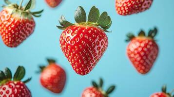 Colorful strawberries on a blue background create a vibrant pattern. photo