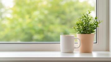 A cozy window scene with a mug and potted plant. photo
