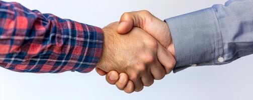Handshake between two people wearing different shirts. photo
