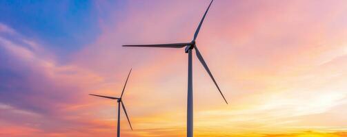 Wind turbines against a colorful sunset sky. photo