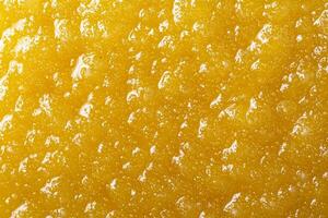 Golden beer bubbles on a textured surface. photo