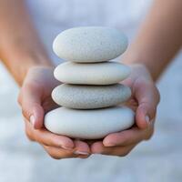 Stacked stones held in hands symbolize balance and harmony. photo