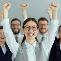Cheerful team celebrating success with raised arms and smiles. photo