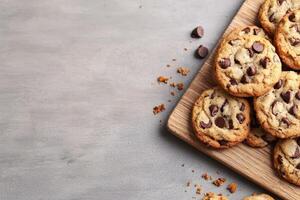 Freshly chocolate chip cookies on a wooden board. photo