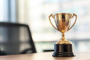 Shiny trophy on a table in a modern office setting. photo