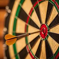 Dart embedded in a dartboard, showcasing precision and focus. photo