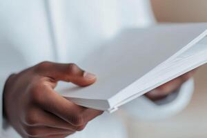 Person holding a book with a blurred background. photo