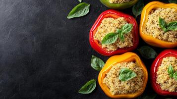Colorful bell peppers filled with quinoa and garnished with leaves. photo