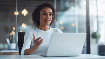 Professional woman engaging in a virtual meeting with a laptop. photo