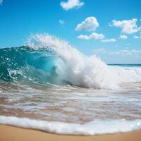 Vibrant ocean wave crashing on sandy beach under a clear blue sky. photo