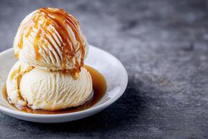 Delicious ice cream with caramel sauce in a white bowl. photo