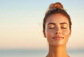 Relaxed woman with a facial mask enjoying the ocean breeze. photo