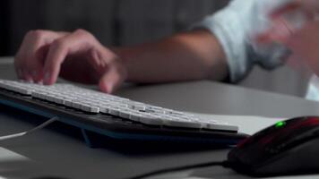 Focused hands of a man typing swiftly on a sleek computer keyboard video