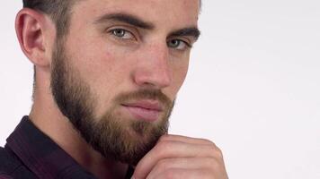 Thoughtful handsome man with a beard gazing into the distance, deep in contemplation video
