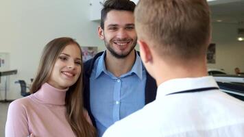 Couple joyfully receives car keys from the salesman video