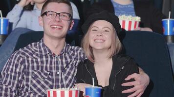 Joyful couple enjoying a movie night in the multiplex video