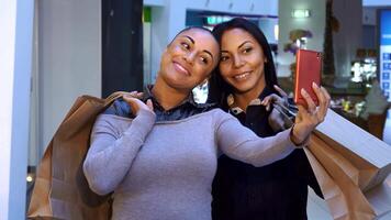 Joyful women capturing a selfie with shopping bags in hand video