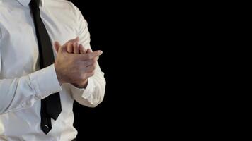 Caucasian man folding his palms in a confident gesture against a sleek black background video