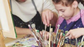 Joyful family creating art together in a vibrant studio video