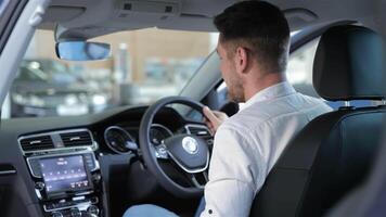 Enthusiastic man interacts with car console touchscreen video